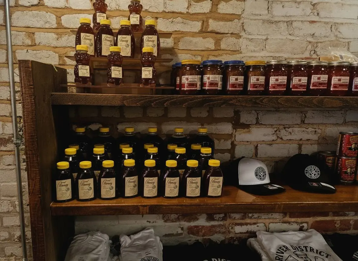 Local honey and preserves beside RDMM caps on the shelf