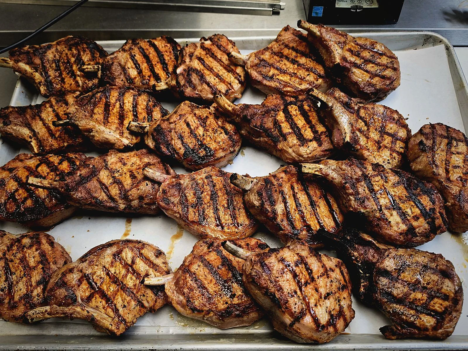 Grilled bone-in pork chops on a tray