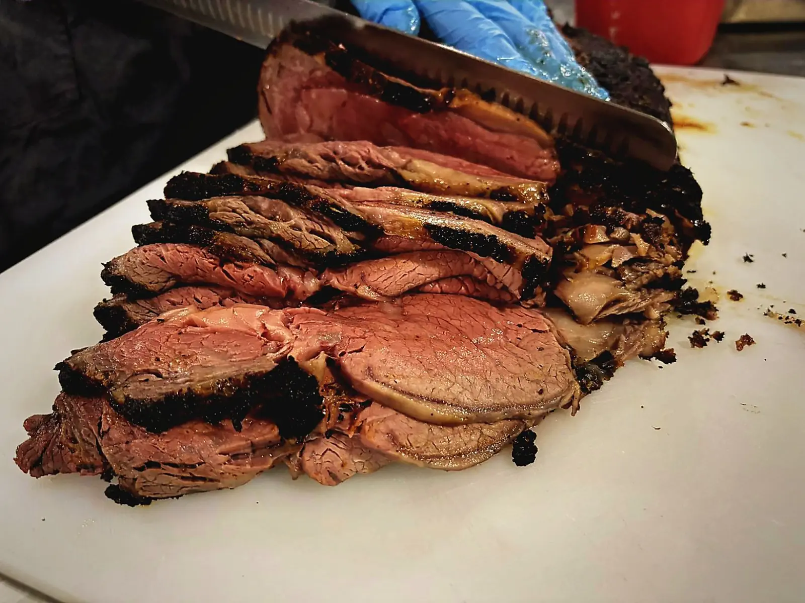 A prime rib roast sliced on the cutting board